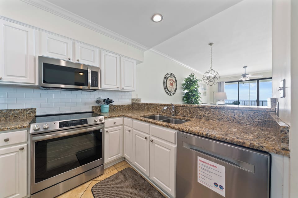 This full kitchen is loaded with stove, oven, dishwasher and even coffee pot.