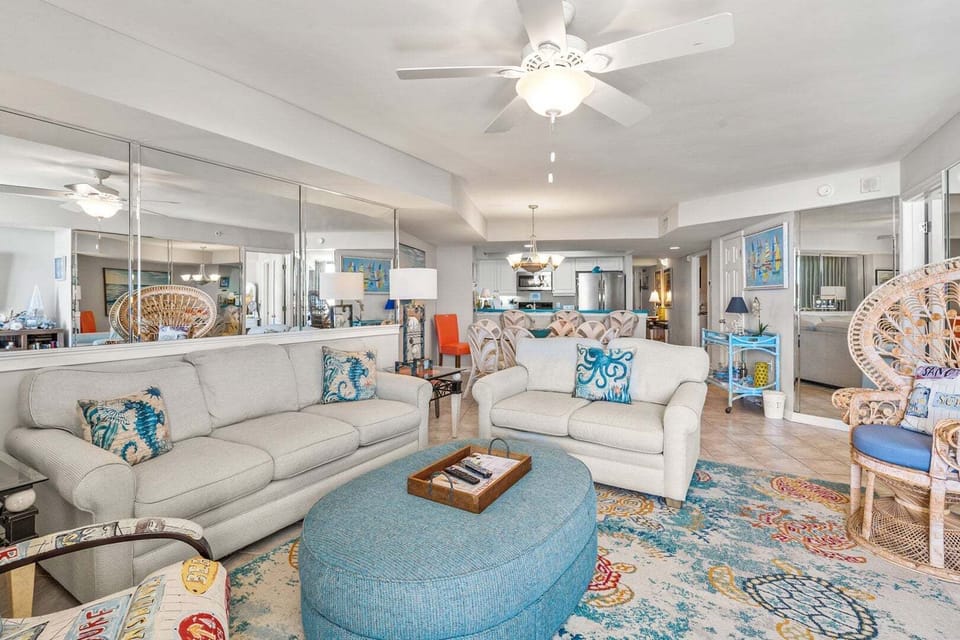 Coastal decor and a mirrored wall in the living room at Ocean Bay Club 107, an Ocean Drive vacation rental