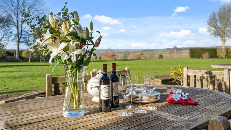 The dining terrace is set with a table and chairs for eight and there is a charcoal BBQ waiting for you.