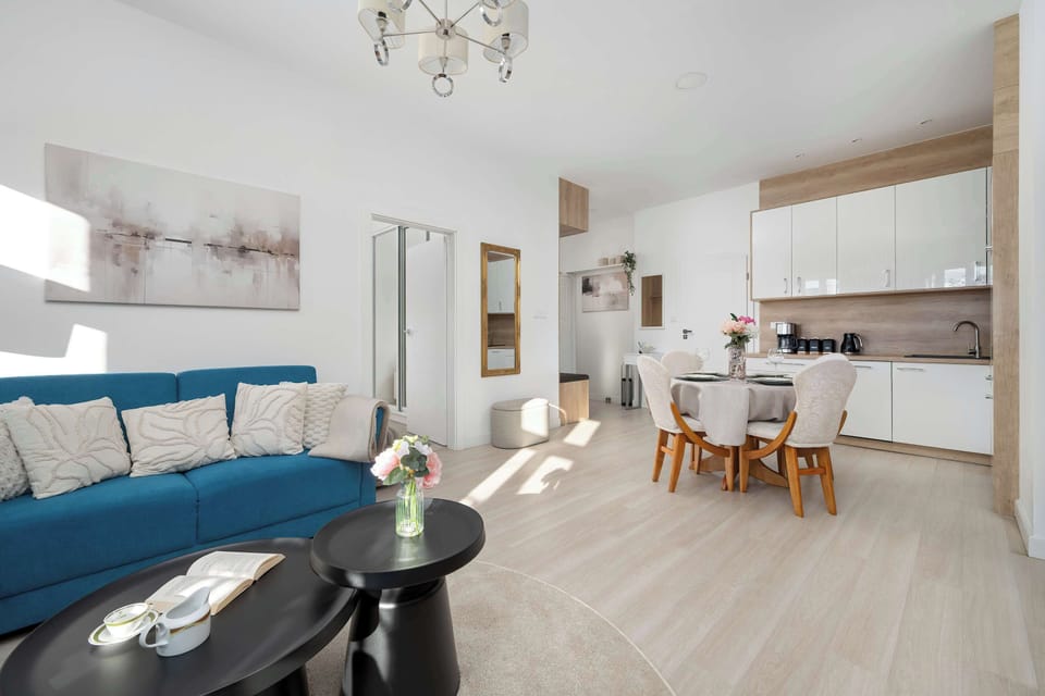 Spacious living room combining seating and dining zones in a bright interior.