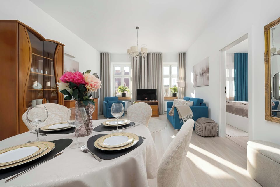 Bright dining corner next to the living room with neatly set table.