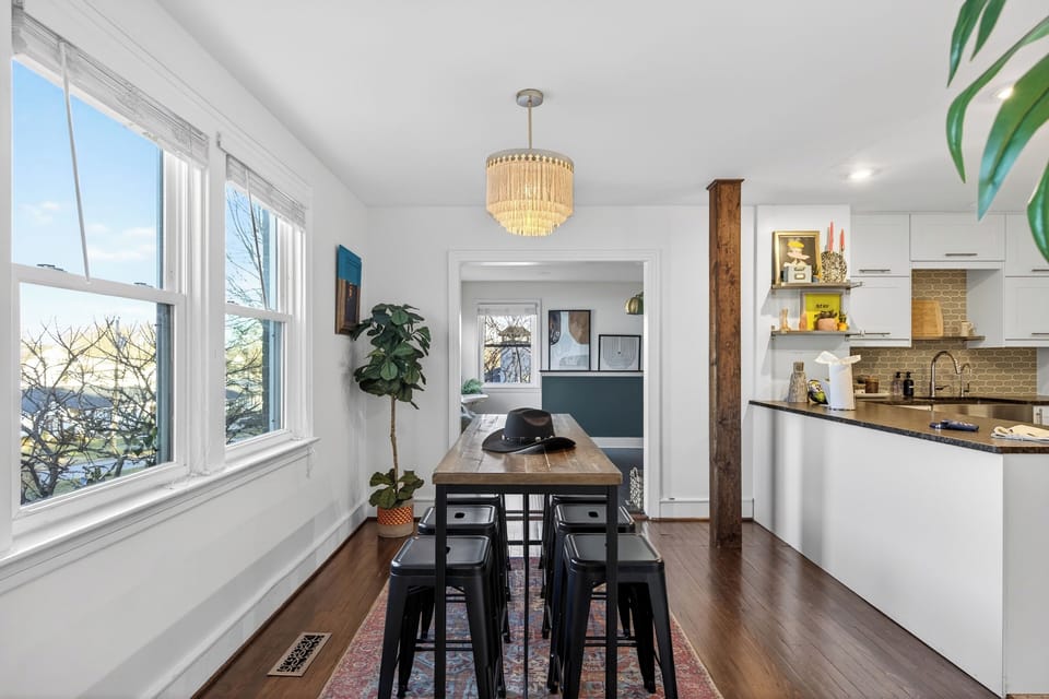 Bright dining nook with a farmhouse table, modern seating, and easy flow into the kitchen—ideal for shared meals and casual gatherings.