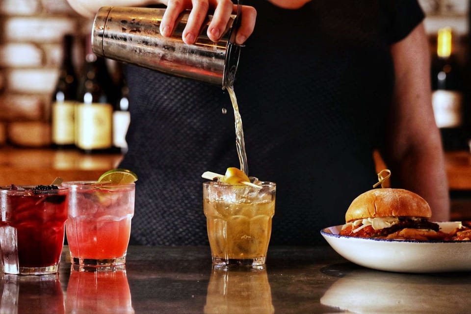 Fresh cocktails poured at the bar with sliders ready to serve