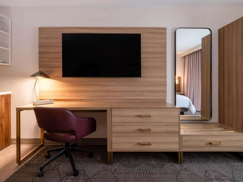 Work desk with chair, TV, mirror, and storage drawers