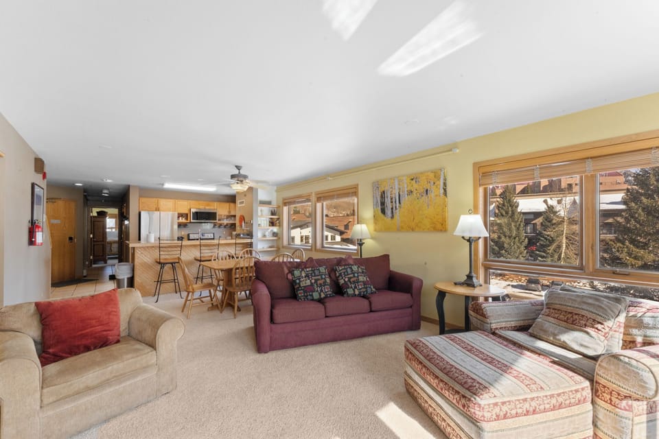 Living area with a wood burning firweplace, TV, and queen sleeper sofa.