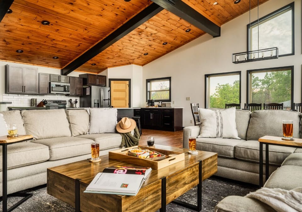Open living room with vaulted ceilings and stone fireplace