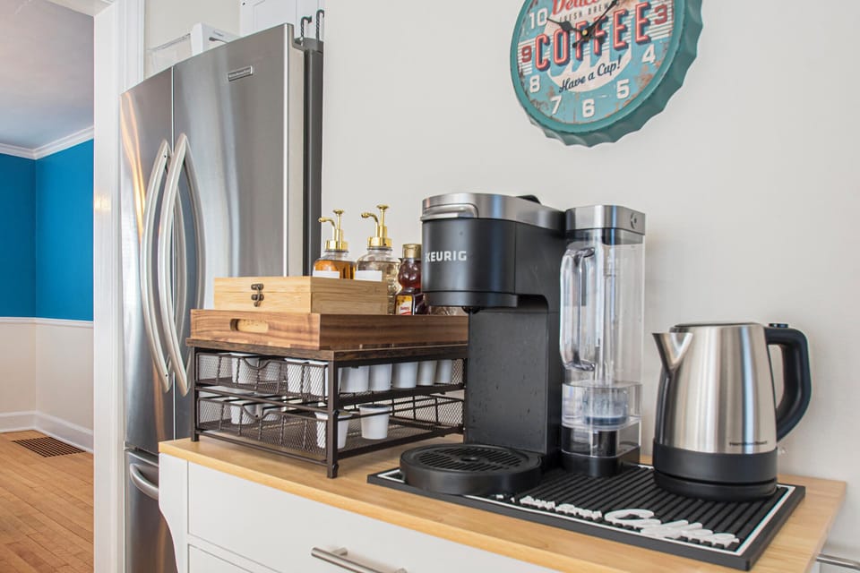 Keurig coffee maker and hot water with a selection of teas.