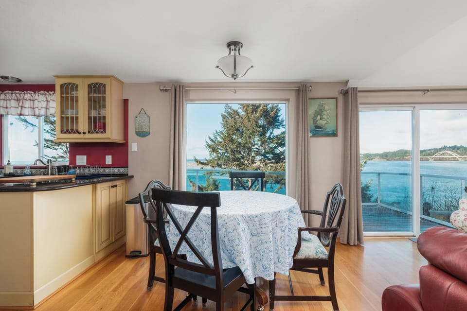 Savor meals while gazing at stunning ocean views through expansive windows that frame the sparkling blue waters perfectly.