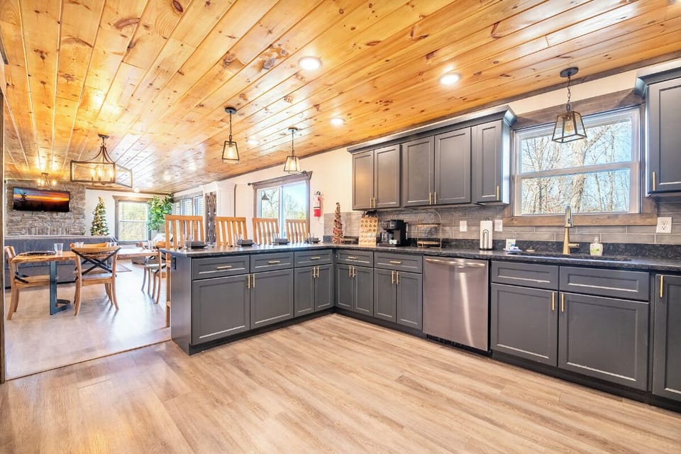 Your spacious kitchen invites culinary adventures with granite counters, stainless appliances, and warm wood accents creating the perfect gathering space.