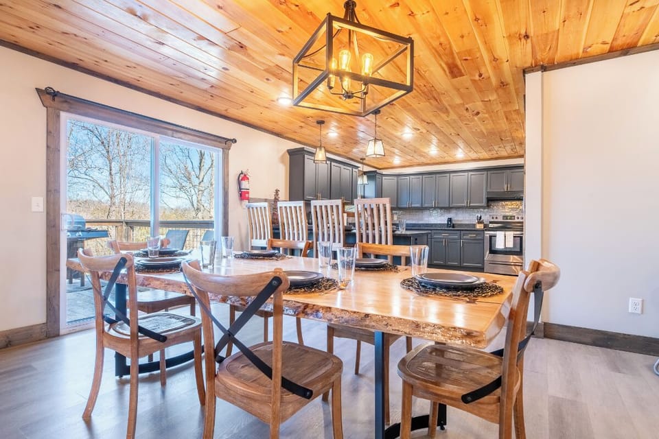 Gather around your rustic dining table beneath warm wood ceilings, where modern comfort meets mountain charm for memorable meals together.