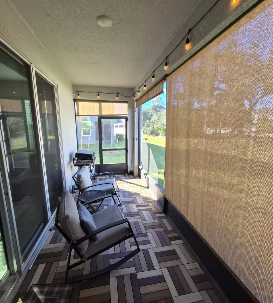 Screened in lanai with privacy shade and gas grill