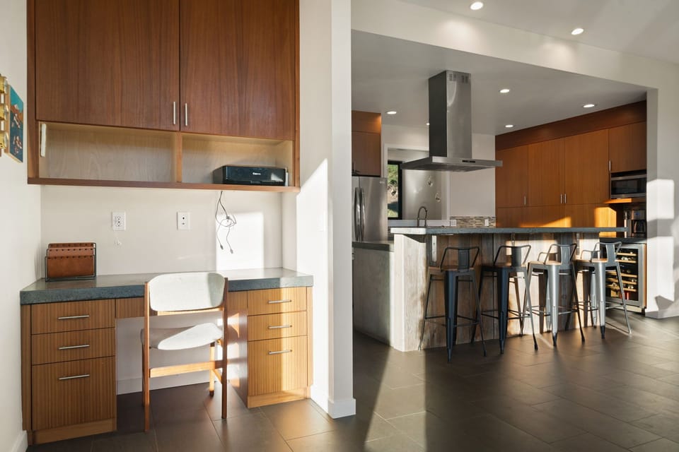 Your fully equipped kitchen flows beautifully into a dedicated workspace, creating the perfect balance for cooking and productivity during your stay.