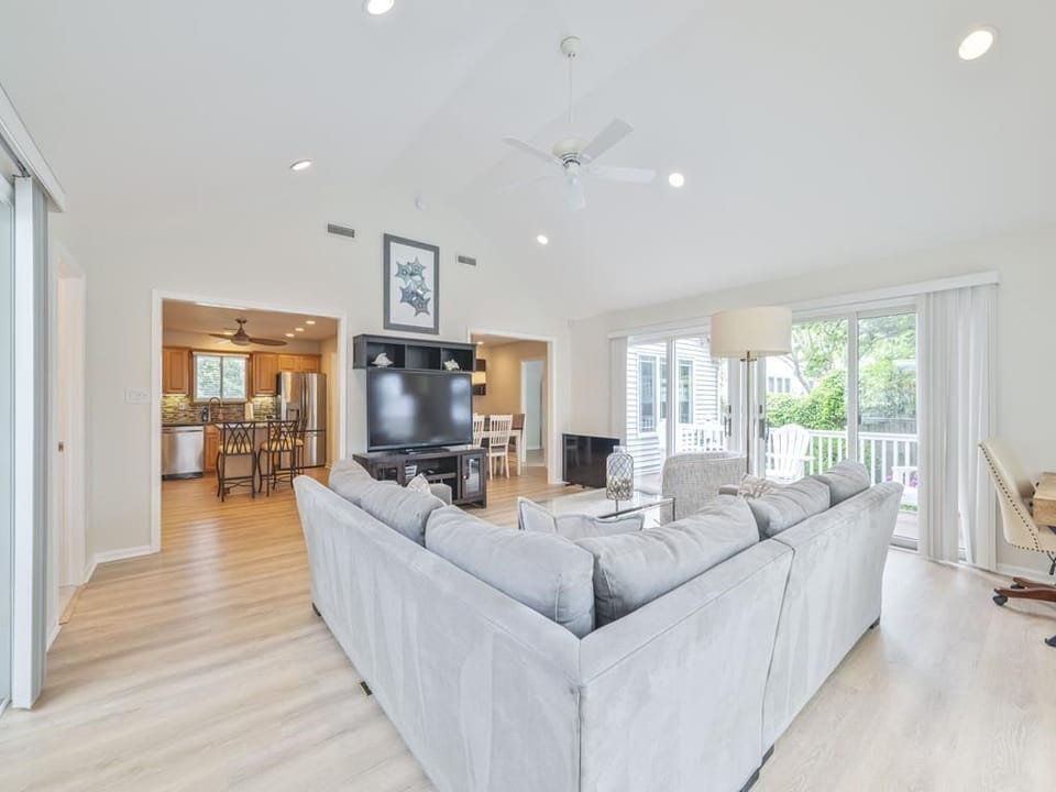 Cozy living area with an open view into the kitchen and dining spaces, perfect for relaxing together.