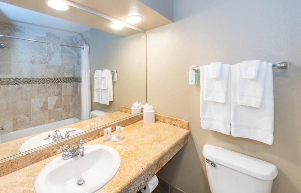 Start your day fresh at a bright vanity with fluffy towels.