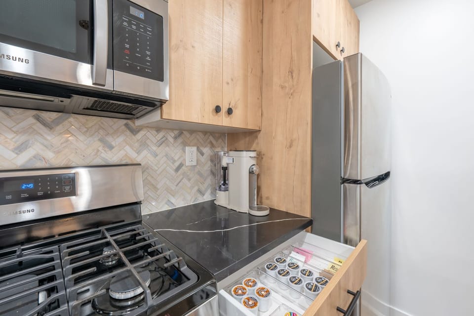 A dedicated coffee station with a modern brewer and a variety of pods. It is a small detail designed to make your morning routine a little easier.