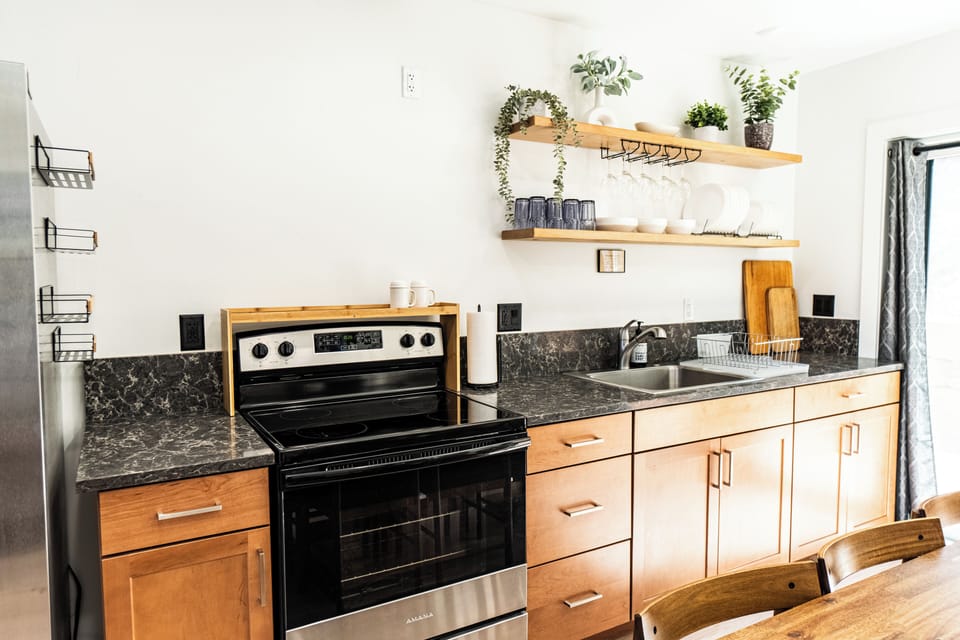 Bright modern kitchen with open shelving and warm wood finishes