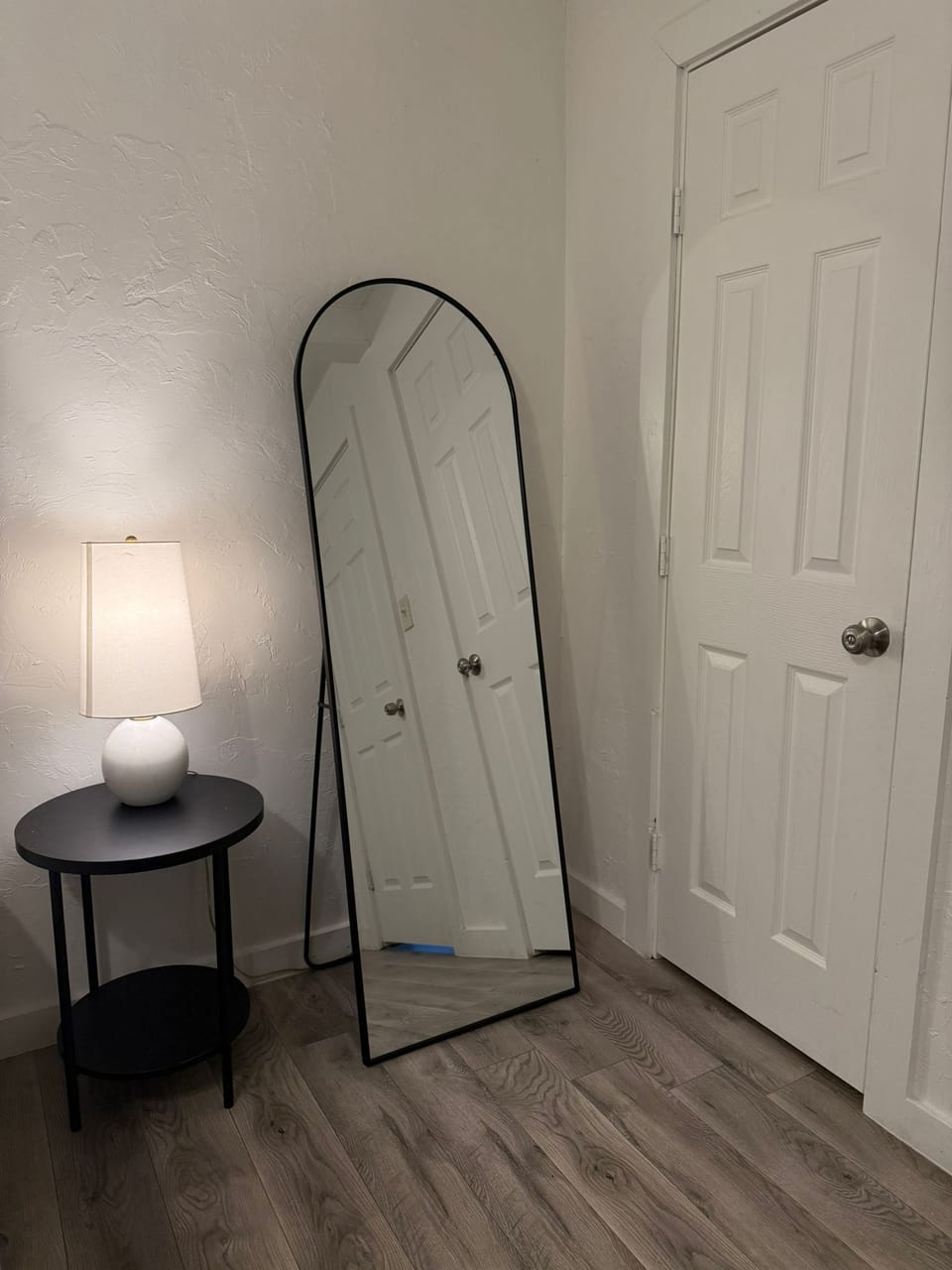 Bright, full-length mirror adds convenience for dressing and outfit checks.