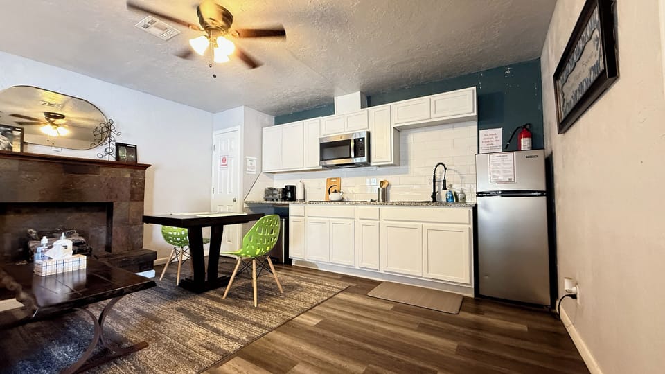 Cook, reheat, or brew — this kitchen has a microwave, fridge, and all the basics for an easy meal at home.