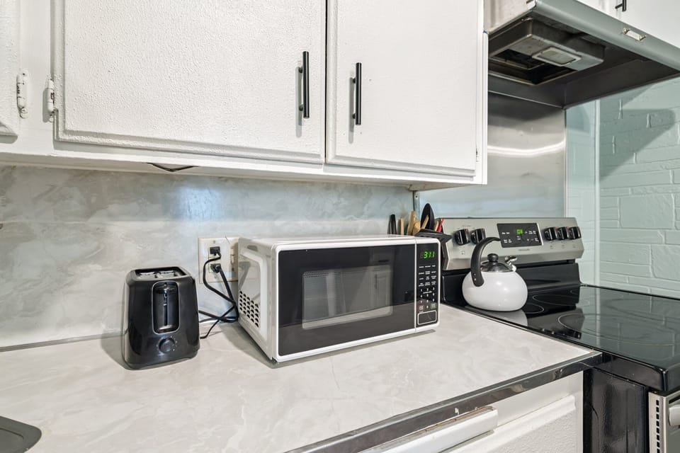 Kitchen essentials including microwave, toaster, and stove for quick and easy meals.
