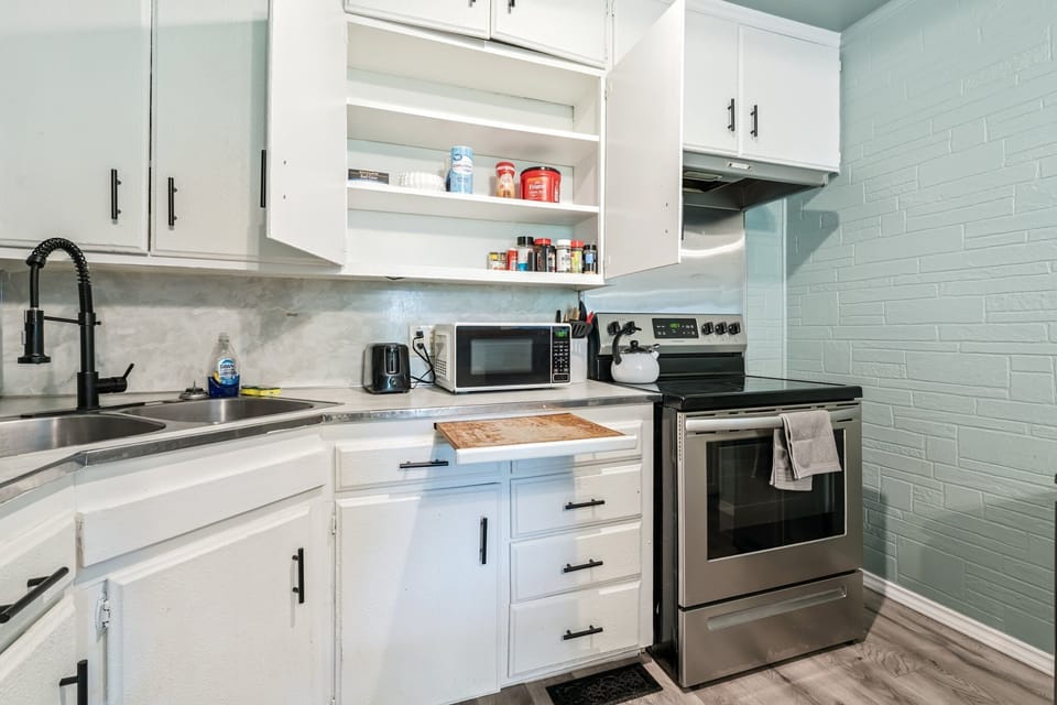 Kitchen — electric range, full-size fridge, coffee maker