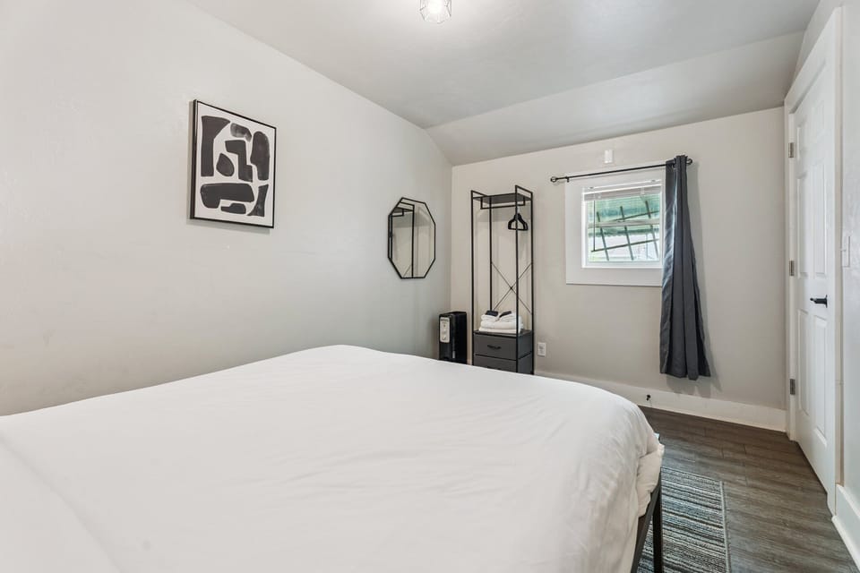 A soft color palette, blackout curtain, and clean lines make this room the perfect retreat after a day out exploring.