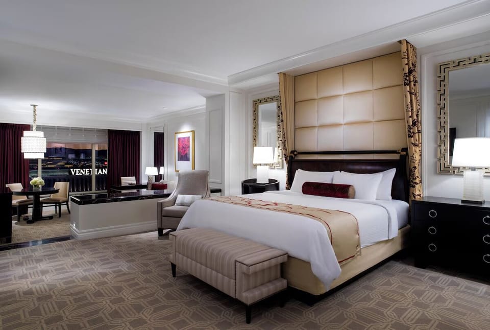 Recharge in a refined bedroom with a bright sitting area.