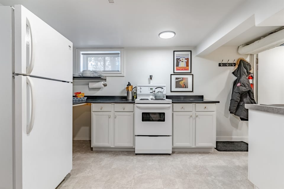 Basic cooking setup with stove, cookware, and dishware for simple meals.