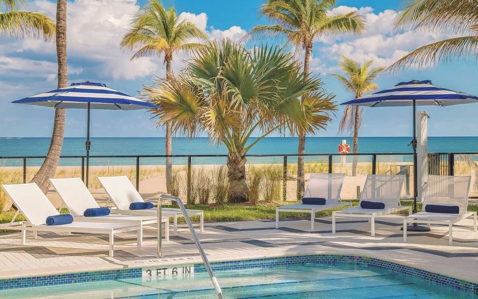 Soak up ocean breezes from loungers beside the shimmering pool.