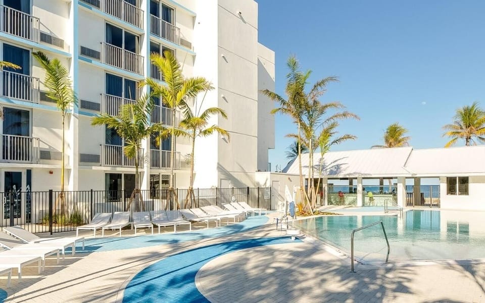 Stretch out on sleek loungers by the sunlit resort pool.
