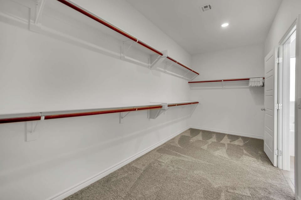 A spacious walk-in closet with plenty of hangers for your convenience