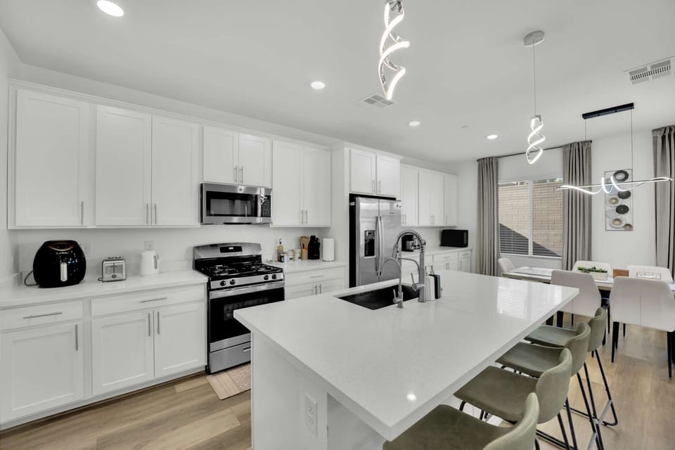 A fully stocked spacious kitchen with a clean and modern design.