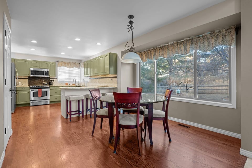 Spacious dining room with hardwood floors and plenty of natural light for family gatherings.