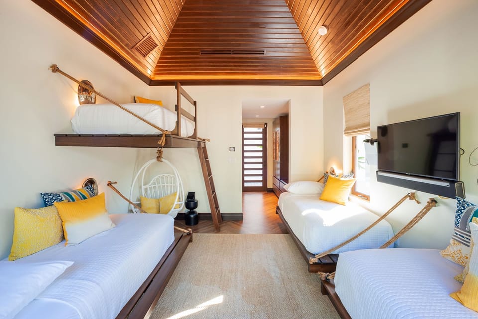 Bedroom 6 is also in the detached bungalow and comes furnished with 4 twin beds, a SmartTV with sound bar, and a video game console. 