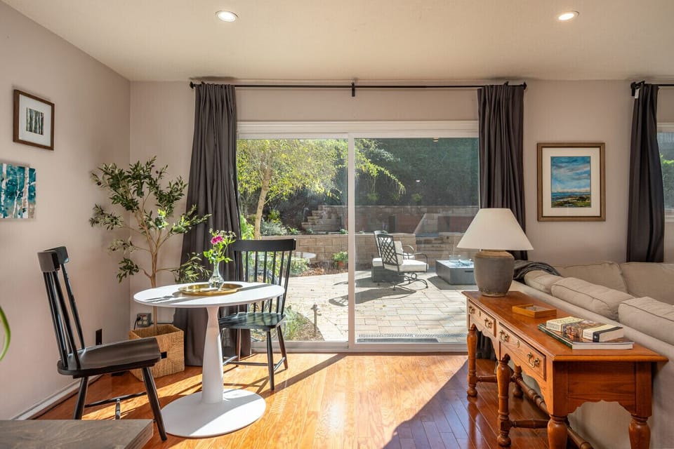 Sun-filled living space with easy access to the private patio, perfect for morning coffee or winding down after work. A comfortable indoor-outdoor flow designed for longer, easygoing stays.
