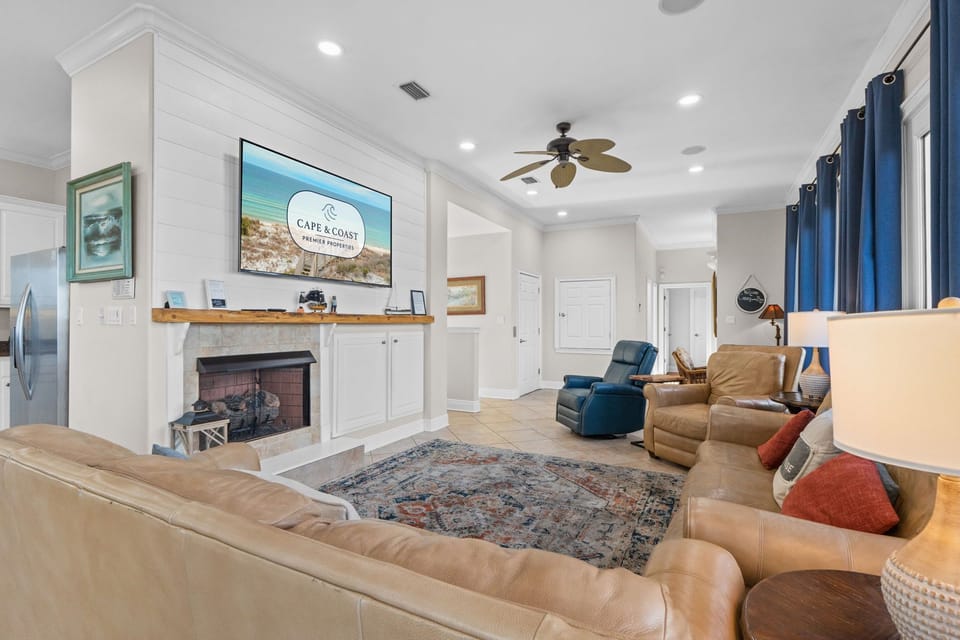 Unwind in your spacious living room with plush leather seating, cozy fireplace, and large TV for perfect movie nights together.