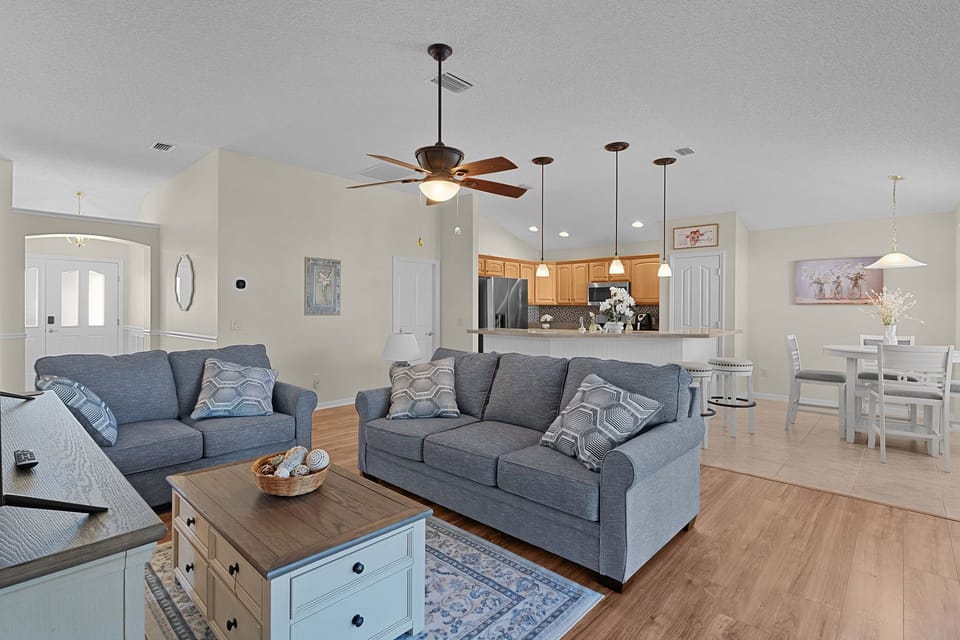 Unwind in this spacious open-concept retreat where coastal-inspired furnishings meet modern comfort, perfect for your family gatherings and relaxing evenings.