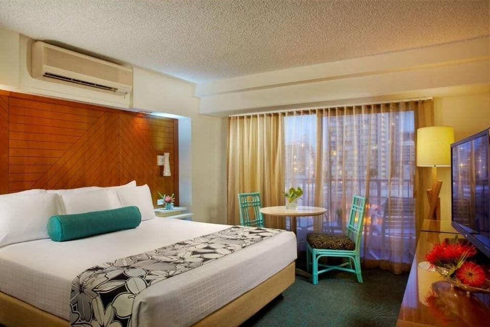 Unwind on crisp linens with city lights beyond curtains.