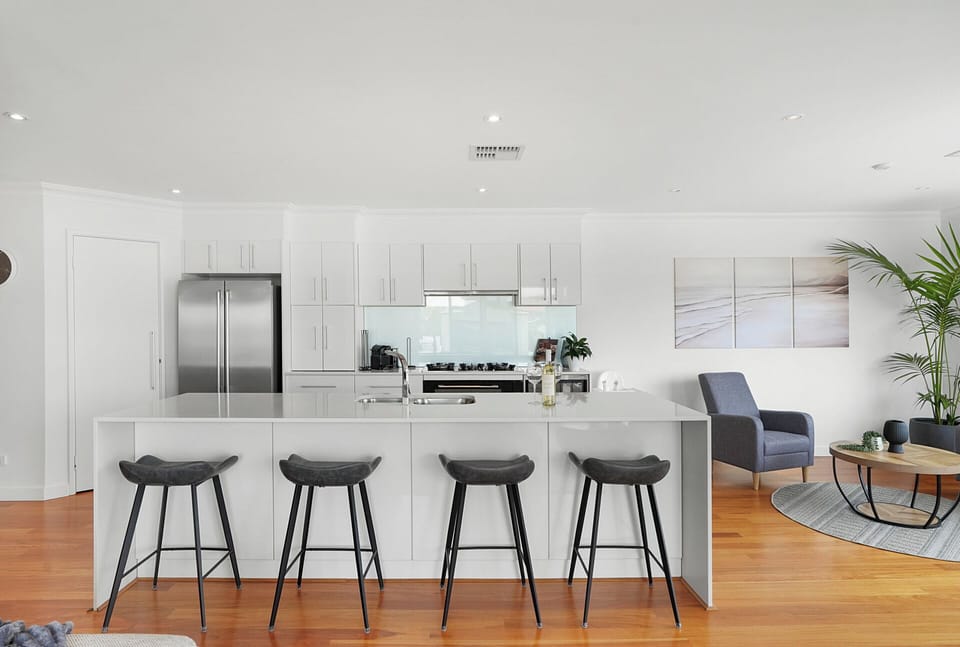 Sleek open kitchen with spacious island seating, perfect for casual dining and socialising