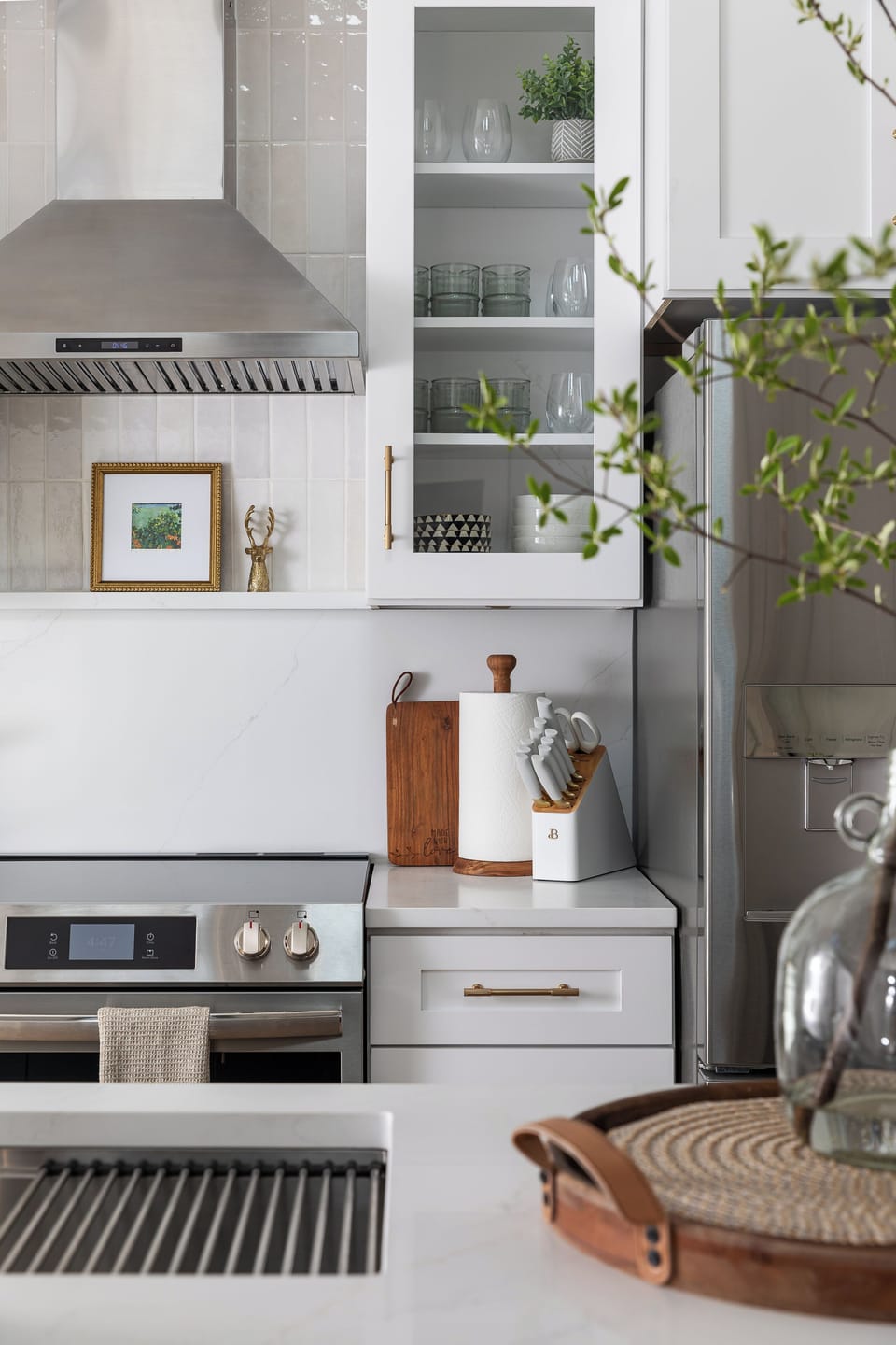 Chic, fully equipped kitchen with quartz tops and glass-front cabinetry