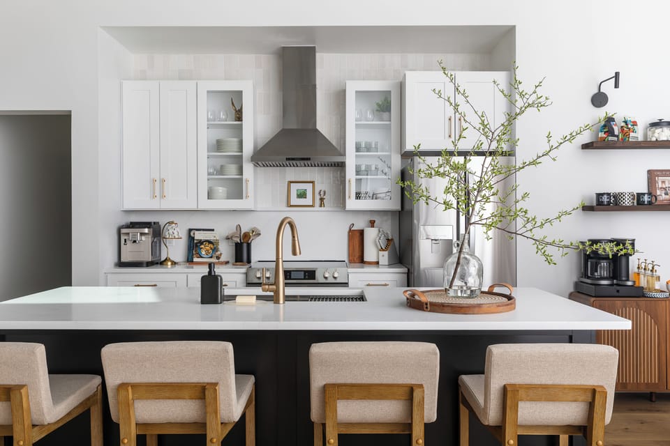 Stylish chef’s kitchen with island seating, coffee bar, and stainless appliances