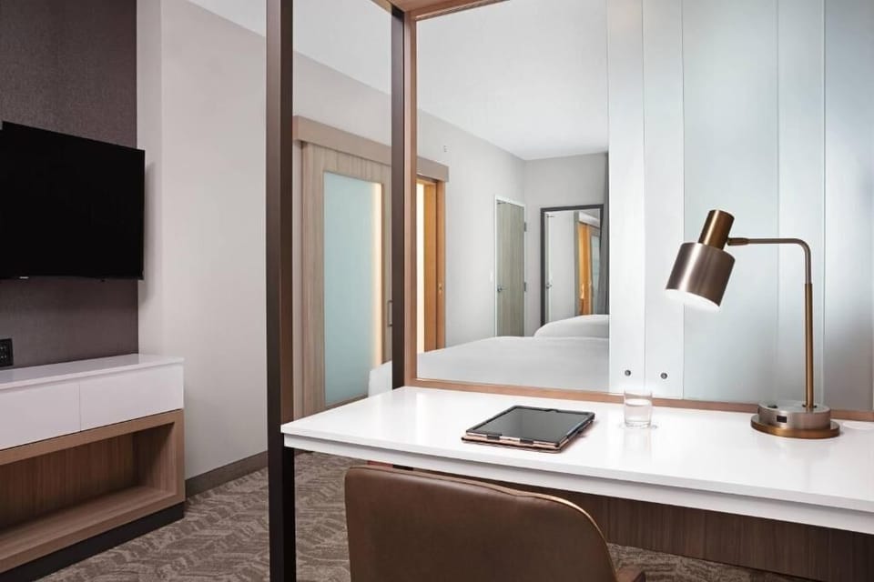 Catch up on emails at a polished desk with warm task lighting.