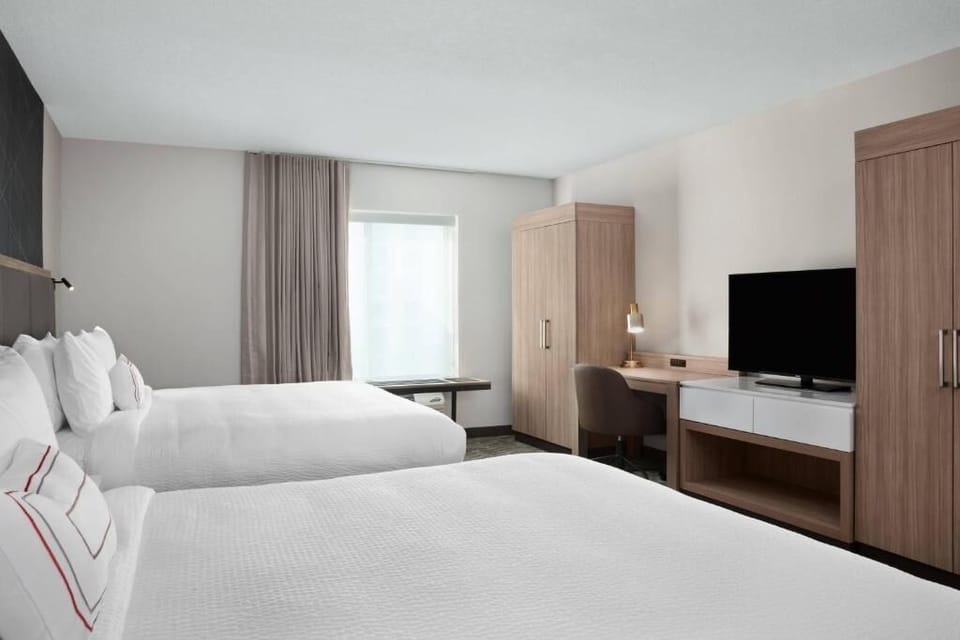 Recharge in bright comfort with two plush beds and ample storage.