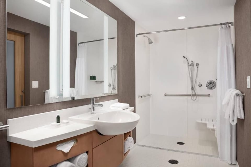 Refresh in a spotless walk-in shower with plush towels.