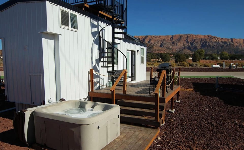 Unwind in the hot tub on the tiny home’s deck, surrounded by nature. Soak in the warm, bubbling water while enjoying peaceful views, making it the perfect spot to relax after a long day. A cozy and private retreat under the open sky.