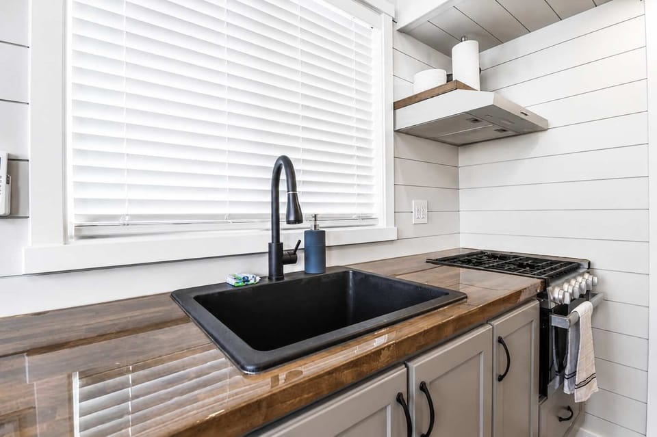 Modern kitchen with a deep farmhouse-style sink, gas cooktop, generous counter space, and contemporary finishes. Everything you need to prepare meals, snacks, or morning coffee while enjoying your Southern Utah getaway near Zion National Park.