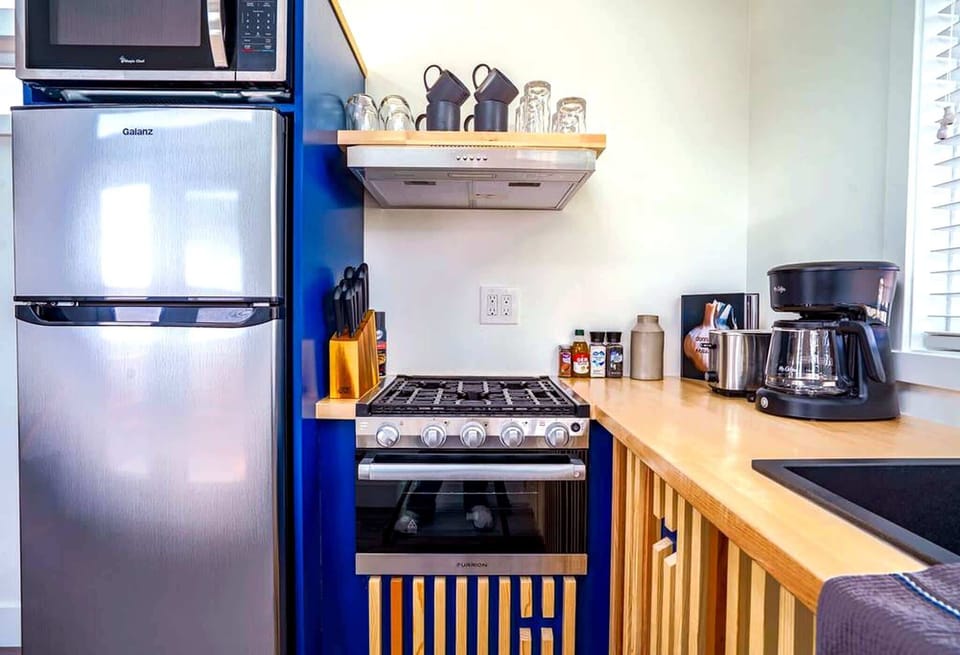 Well-equipped kitchen with a refrigerator, stove, oven, microwave, coffee maker, cookware, dishes, and utensils. Everything you need to prepare meals, enjoy morning coffee, and feel at home while exploring Southern Utah.