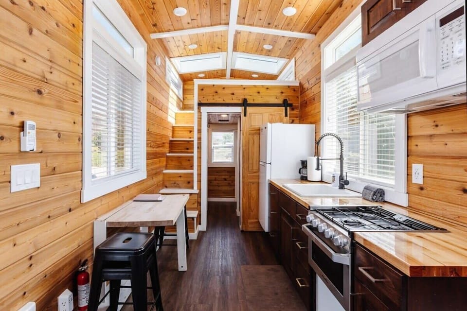 The kitchen is fully equipped with a refrigerator, freezer, microwave, stove and oven, and sink with hot/cold water. Enjoy coffee from the coffee maker, with cookware, dishes, utensils, and plenty of storage cabinets to keep everything organized.