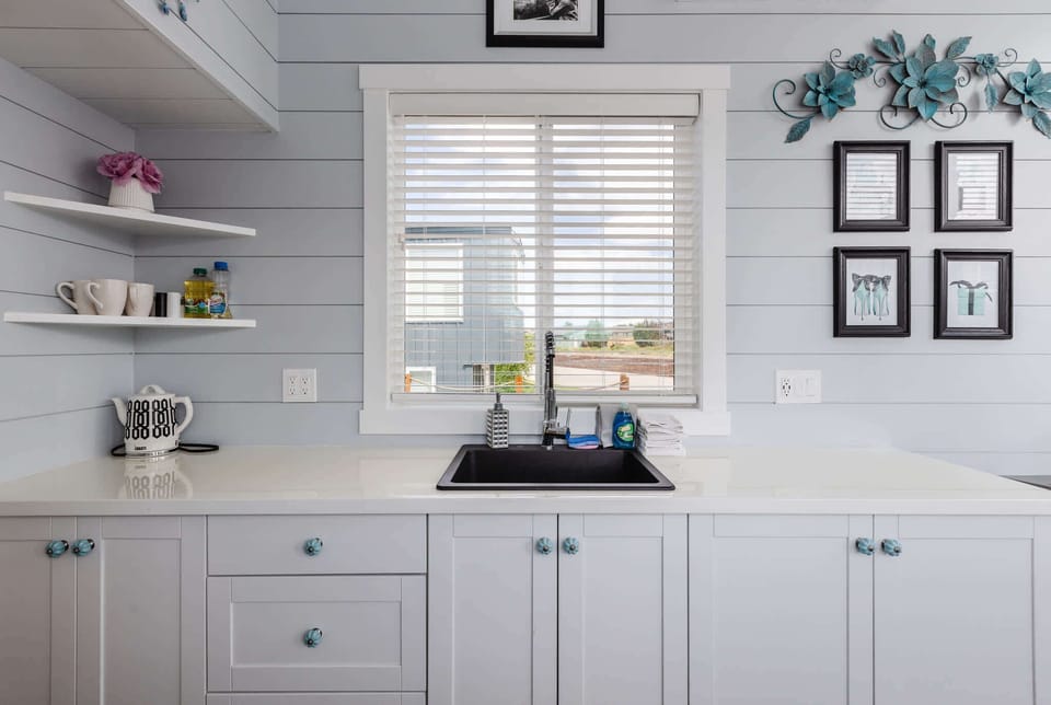 The kitchen is fully equipped with a refrigerator, freezer, microwave, cooktop, and sink with hot/cold water. Enjoy coffee from the coffee maker, with cookware, dishes, utensils, and plenty of storage cabinets to keep everything organized.