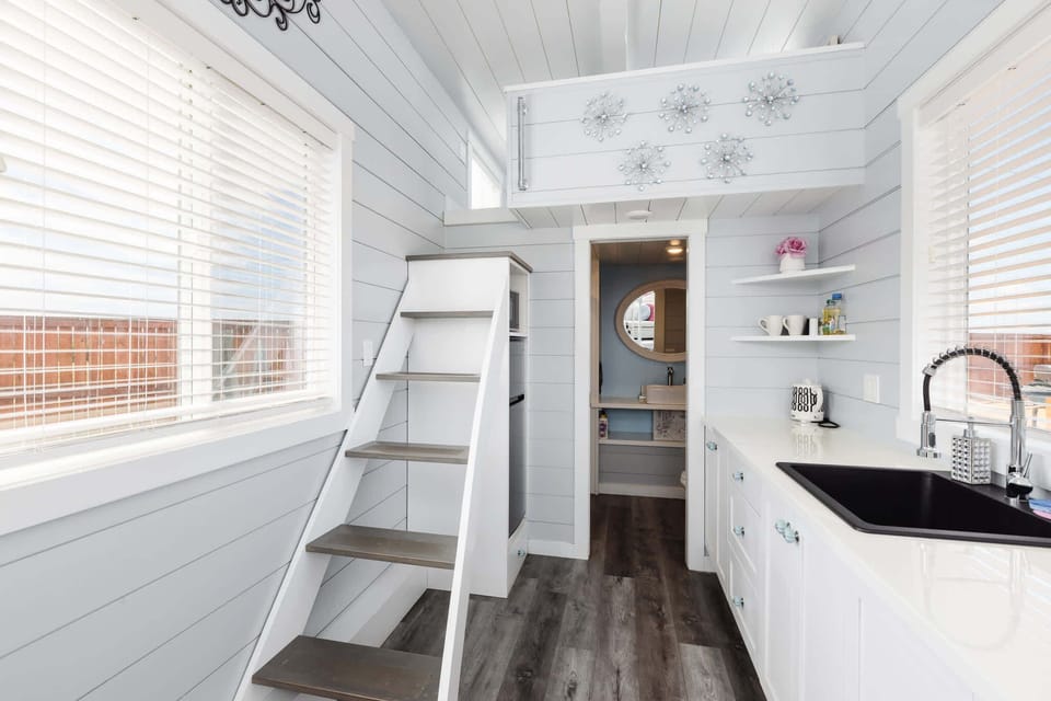 The kitchen is fully equipped with a refrigerator, freezer, microwave, cooktop, and sink with hot/cold water. Enjoy coffee from the coffee maker, with cookware, dishes, utensils, and plenty of storage cabinets to keep everything organized.