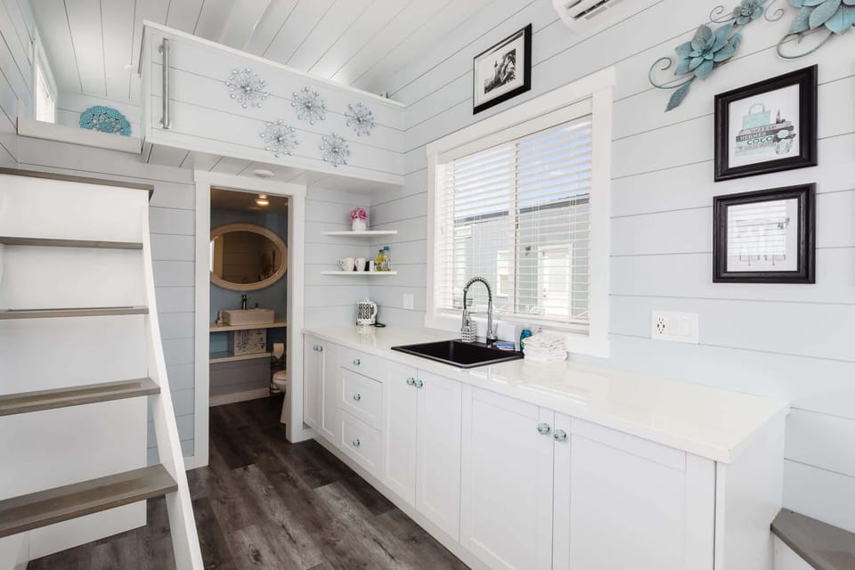 The kitchen is fully equipped with a refrigerator, freezer, microwave, cooktop, and sink with hot/cold water. Enjoy coffee from the coffee maker, with cookware, dishes, utensils, and plenty of storage cabinets to keep everything organized.